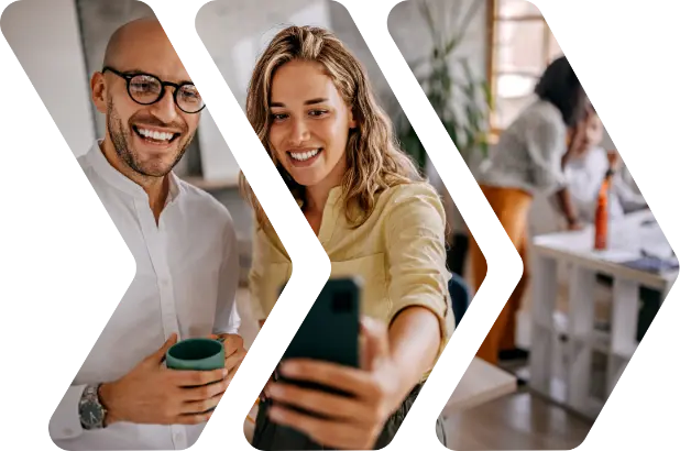 Two people taking a selfie in a brighly-lit office